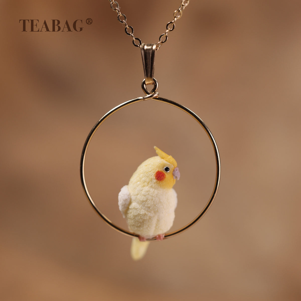 Cockatiel necklace pendant with the full bail, gold-tone hoop and bird visible.