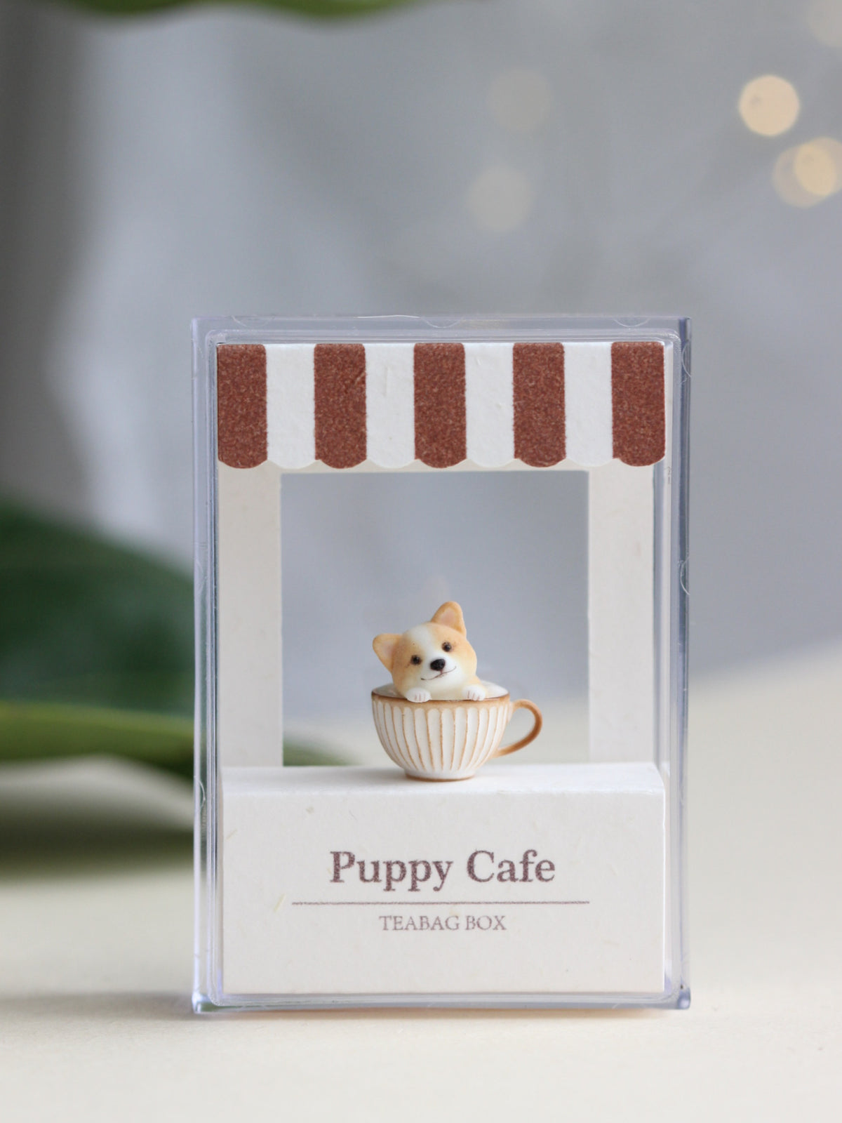 A front-facing Corgi Coffee miniature inside a clear Puppy Cafe display box, shown in its full portrait composition. Design reference only; the miniature and display box are not included with the necklace.