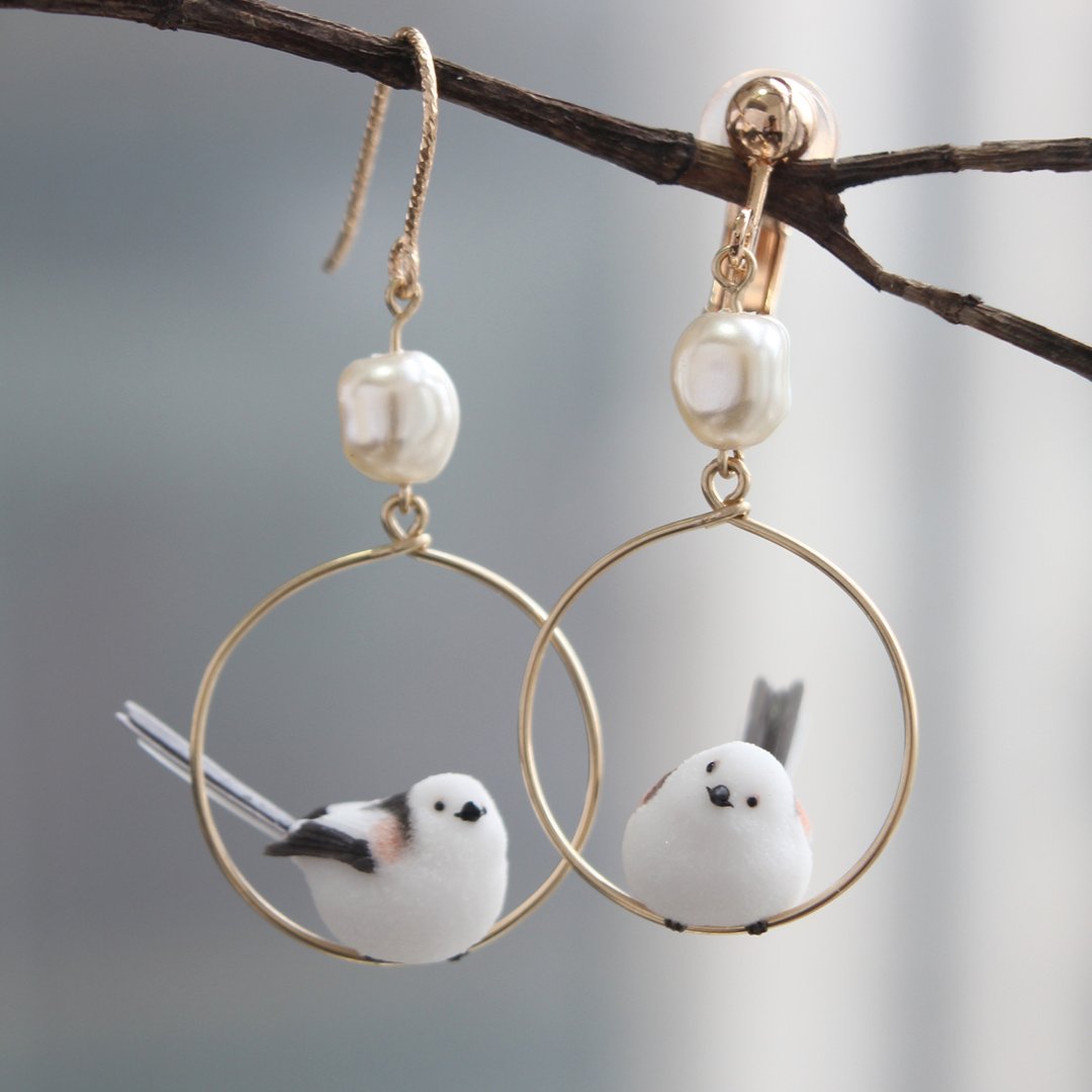 Little Bird earring fitting comparison: one pierced hook and one clip-on shown together on a branch. Each purchased pair uses the selected fitting on both earrings.